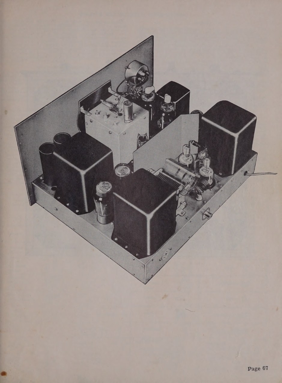 Figure 3 — The chassis from above, as the manual photographed it. The potted transformers and the shielded VFO box dominate; the final amplifier compartment is at the right, its 6146s standing on their own su…