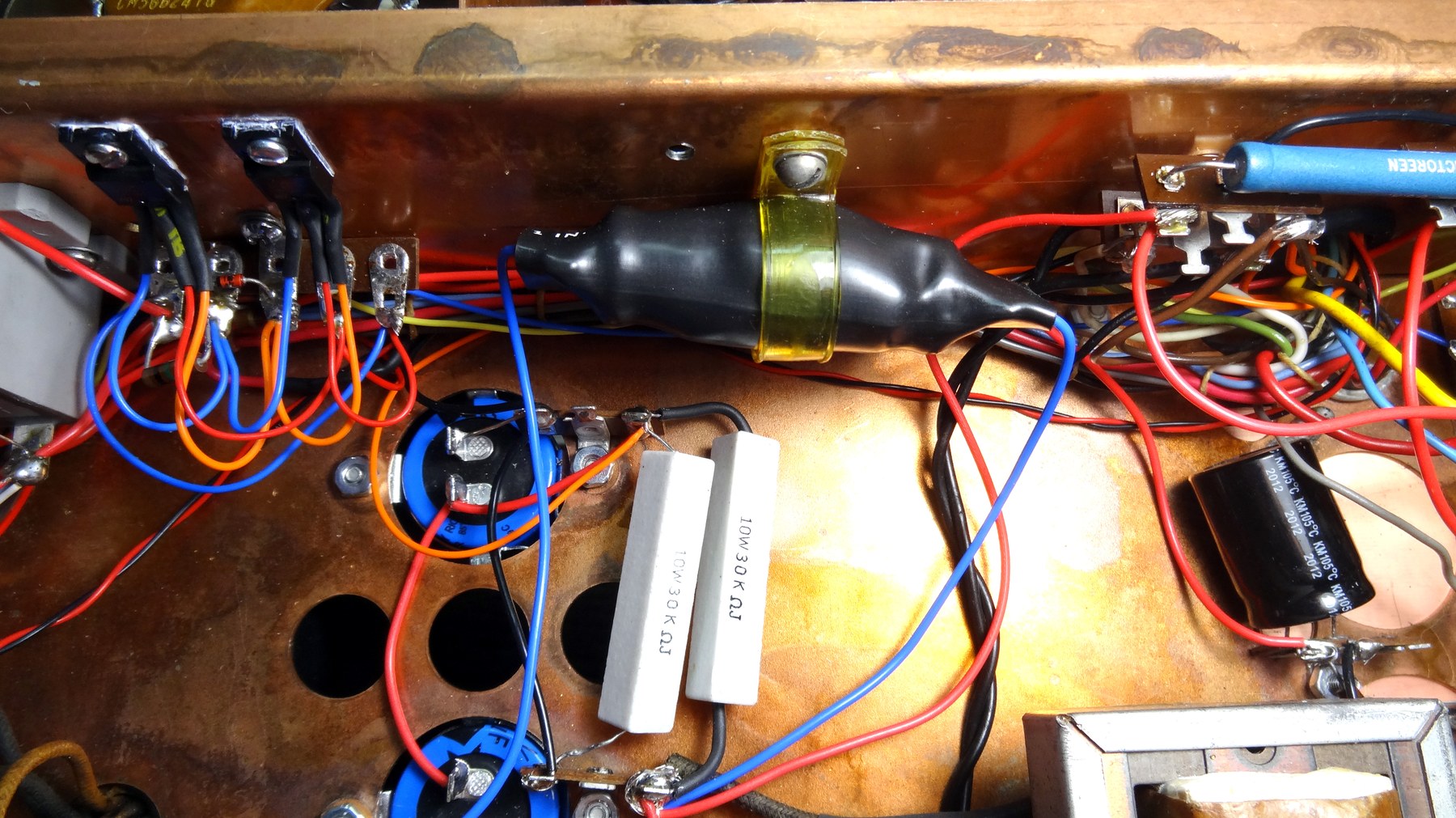 Figure 10 — The high-voltage compartment after rebuilding: silicon rectifier strings in place of the 5R4GYs, new bleeder resistors and new filter capacitors on the copper-plated chassis. Any such conversion ra…