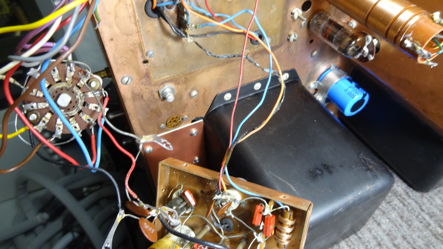 Figure 4 — Inside the VFO compartment during rework. The filament wiring here is a known casualty: in this rig it had burnt black and fused to its neighbours. Everything in the box that gets warm moves the fr…
