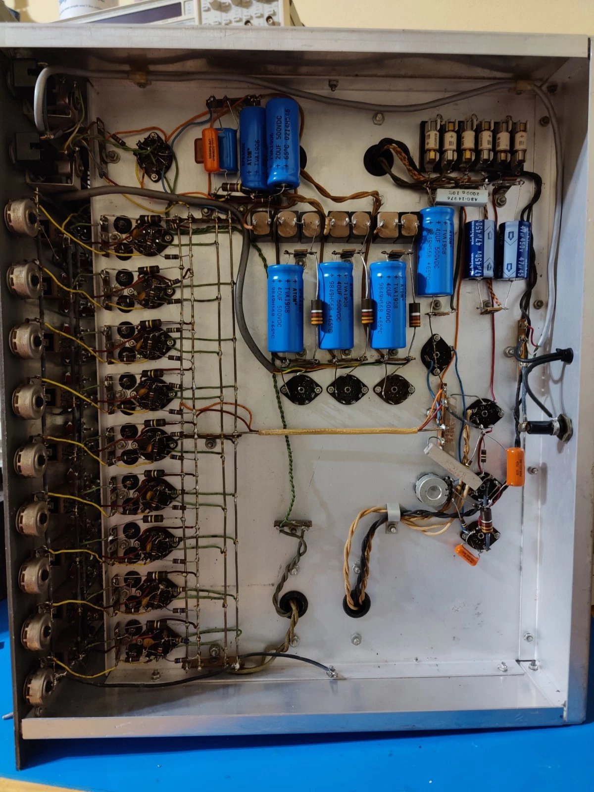 Figure 1 — Chassis interior with all nine amplifier modules visible, tubes in sockets, wiring harness to front panel binding posts.