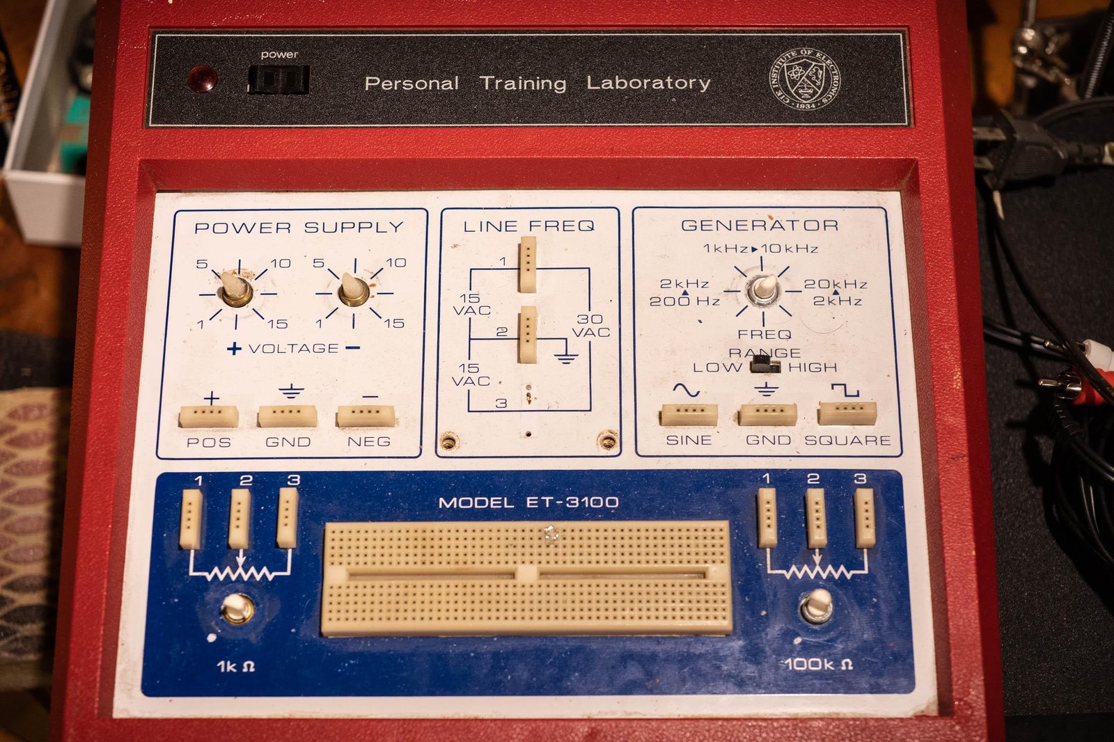 Figure 2 — A red OEM ET-3100 badged "Personal Training Laboratory" with an institutional seal at right, otherwise identical to the Heath panel of the original version. The photograph accompanied an owner's on…